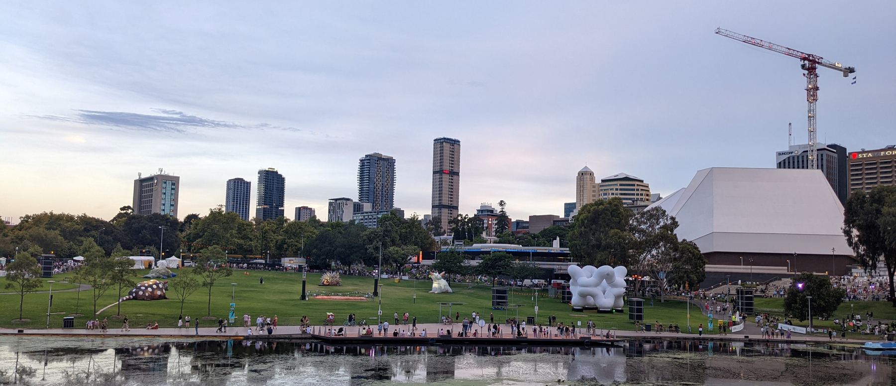 The Adelaide skyline seen across Elder Park and the River Torrens at dusk