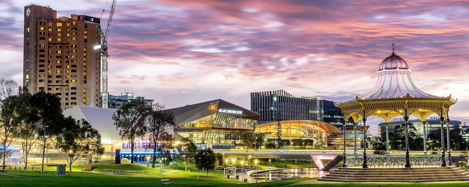 Elder Park rotunda and the Adelaide riverbank glowing at sunset